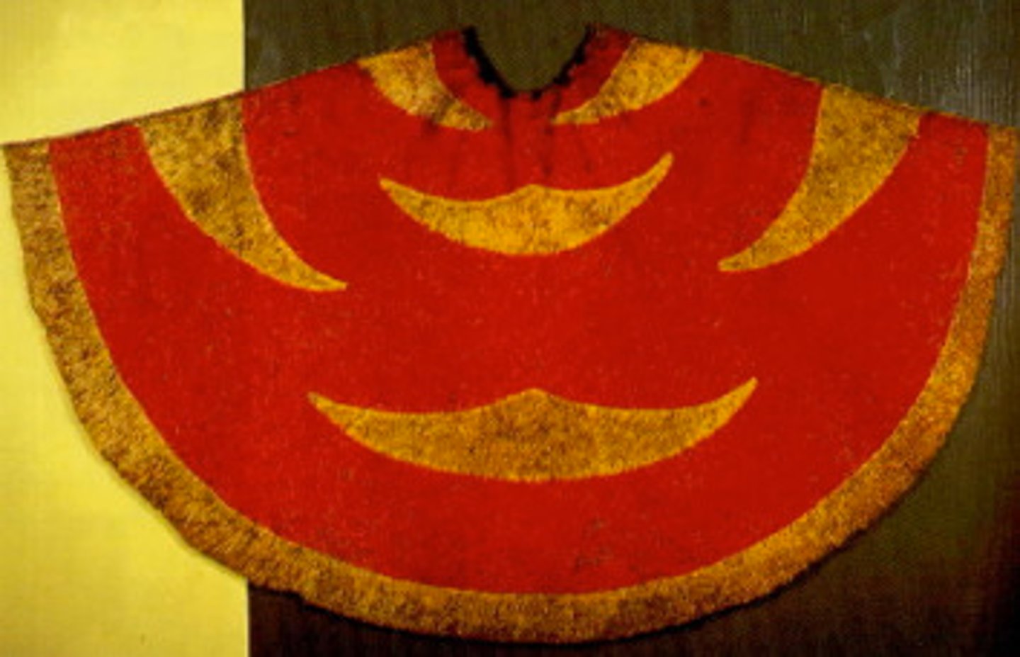 <p>Hawaiian</p><p>Late 18th century CE</p><p>Form: Feathers and fiber</p><p>Function: A cape worn by people with high ranking in nobility, power, or social status</p><p>The red feathers were made from a local 'i'iwi bird. The yellow and black feathers were from the 'o'o bird. Red was considered to be a royal color in Polynesia, while the yellow feathers were prized due to their scarcity. No two capes were identical, but most are similar in color and in the geometrical shapes. The feather capes were worn by men, typically those who were high ranking in nobility, power, or social status</p>
