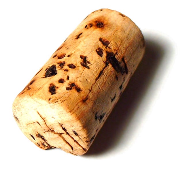 <p>1)a light, soft material that is the thick bark of a type of Mediterranean oak tree<br>-a cork mat<br>-cork tiles<br>2)a small round object made of cork or plastic, that is used for closing bottles, especially wine bottles<br>=to draw the cork<br>=Champagne corks were popping (= people were celebrating).</p>