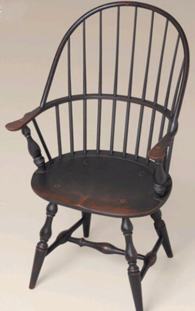 <p>Wood chair whose back and sides consist of thin, turned spindles that are attached to a solid, sculpted seat. Its straight legs splay outward and its back reclines slightly. Comes in fan, hoop, comb, or arch back.</p>