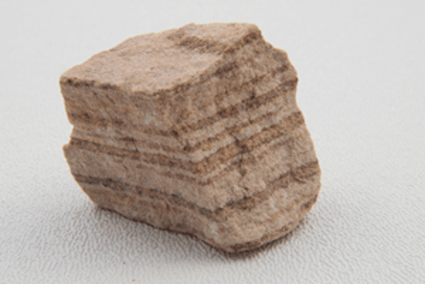 <p>a type of rock that forms when sediment is compacted and cemented over time.</p>