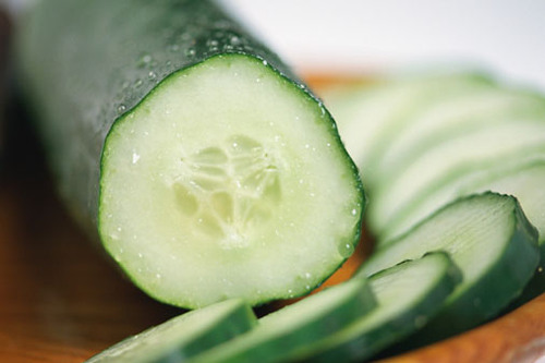 long and narrow. They have raised dots on the outside. They range from yellow-green on the outside, or "silver" slicer cucumbers, which are off-white/yellow, as pictured.
(They are longer and narrower in comparison to Pickle Cucumbers)