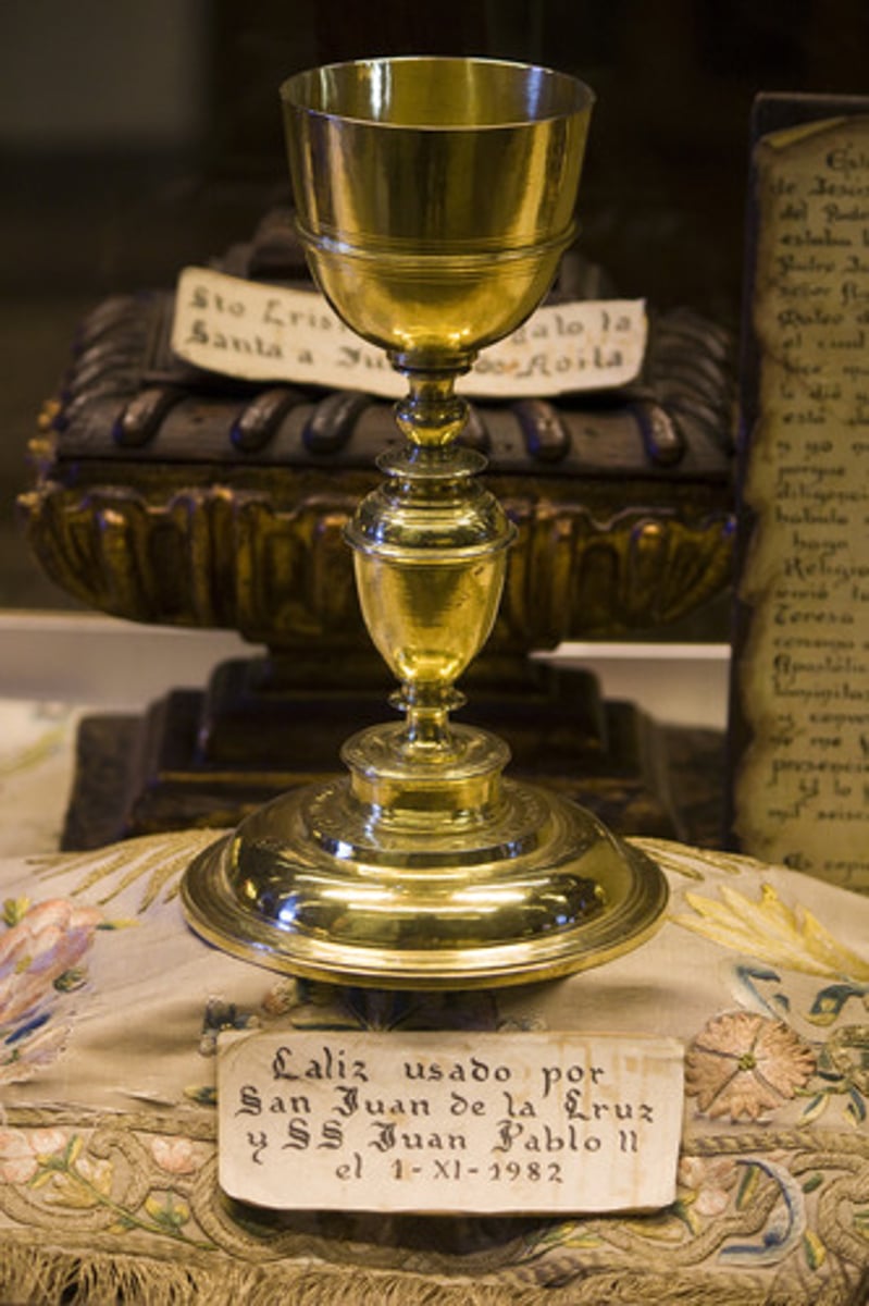 <p>a cup containing wine, used during a Christian service</p>