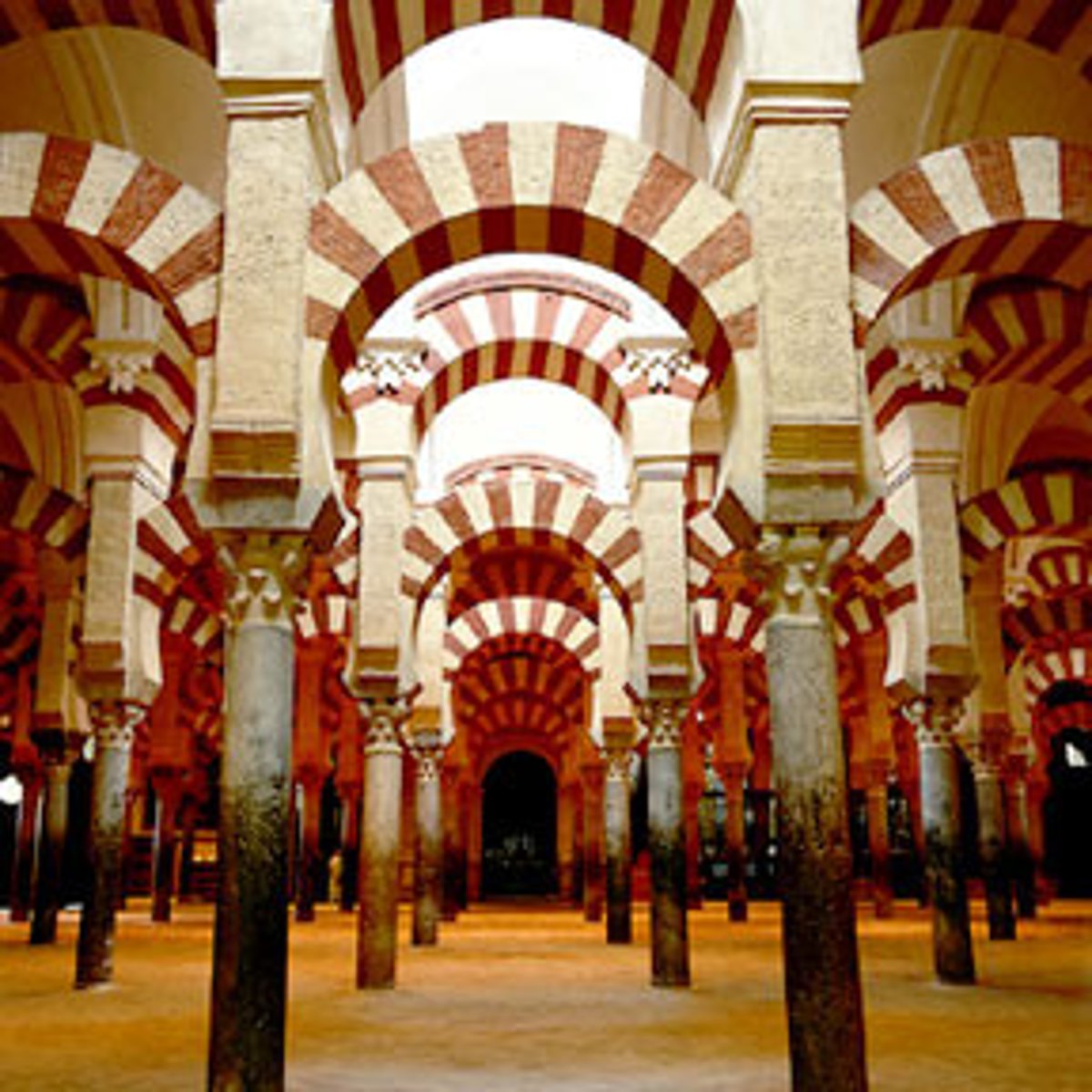 <p>a hypostyle hall, filled with columns topped by large horseshoe-shaped arches that support the roof, typical of traditional Islamic mosques</p>