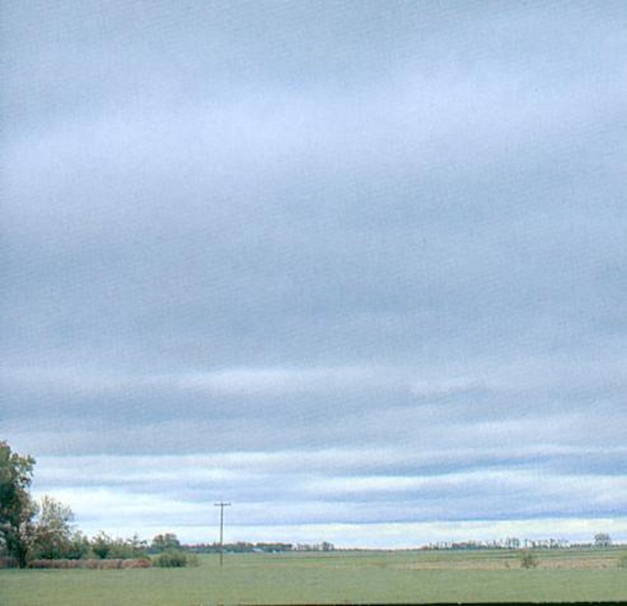 <p>smooth, gray clouds that cover the whole sky (block out direct sunlight). Light rain and drizzle can happen.</p>