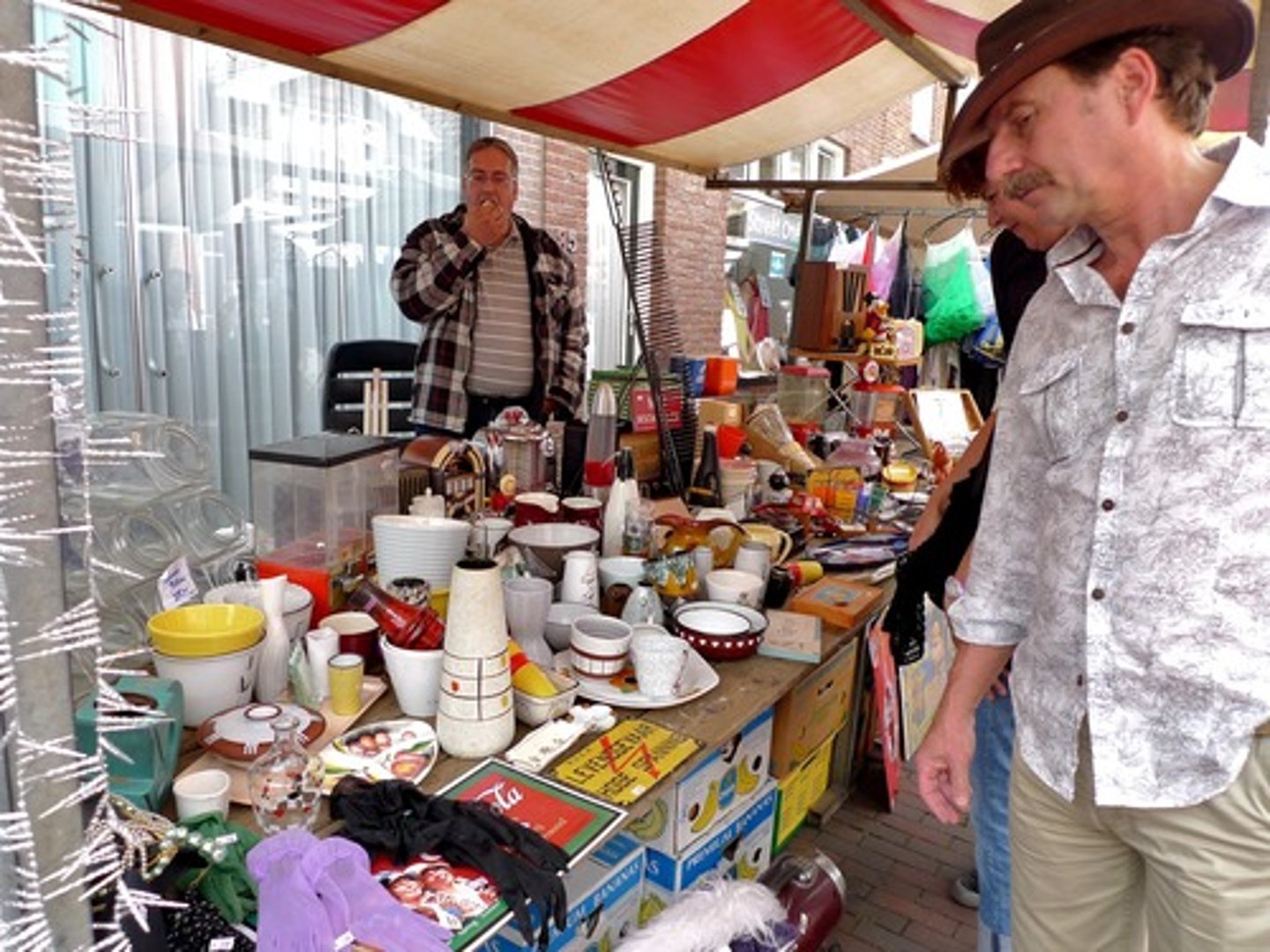 <p>(n) a market, usually taking place outside, where old or used goods are sold cheaply</p>