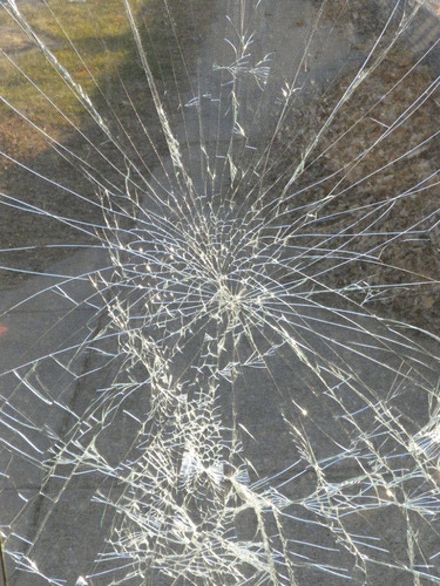 <p>cracks formed on the side opposite the side of the impact, radiate out in all directions from the point of impact</p>