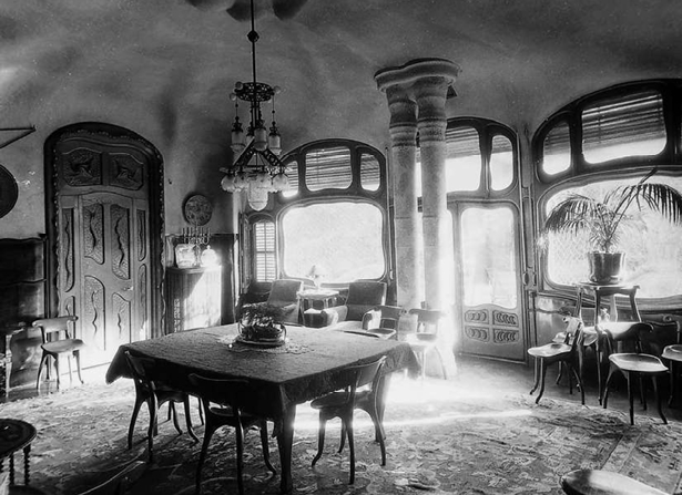 <p>The dining room of _________________ by Antonio Gaudi. It contains table and chairs, door and window frames, paneling, hanging light fixtures, and flowing plaster ceiling forms in Gaudi’s highly personal form of Art Nouveau. </p>