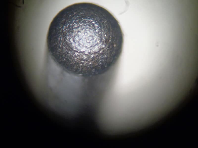 <p>What type of machining likely created the granular pattern seen on this firing pin?</p>