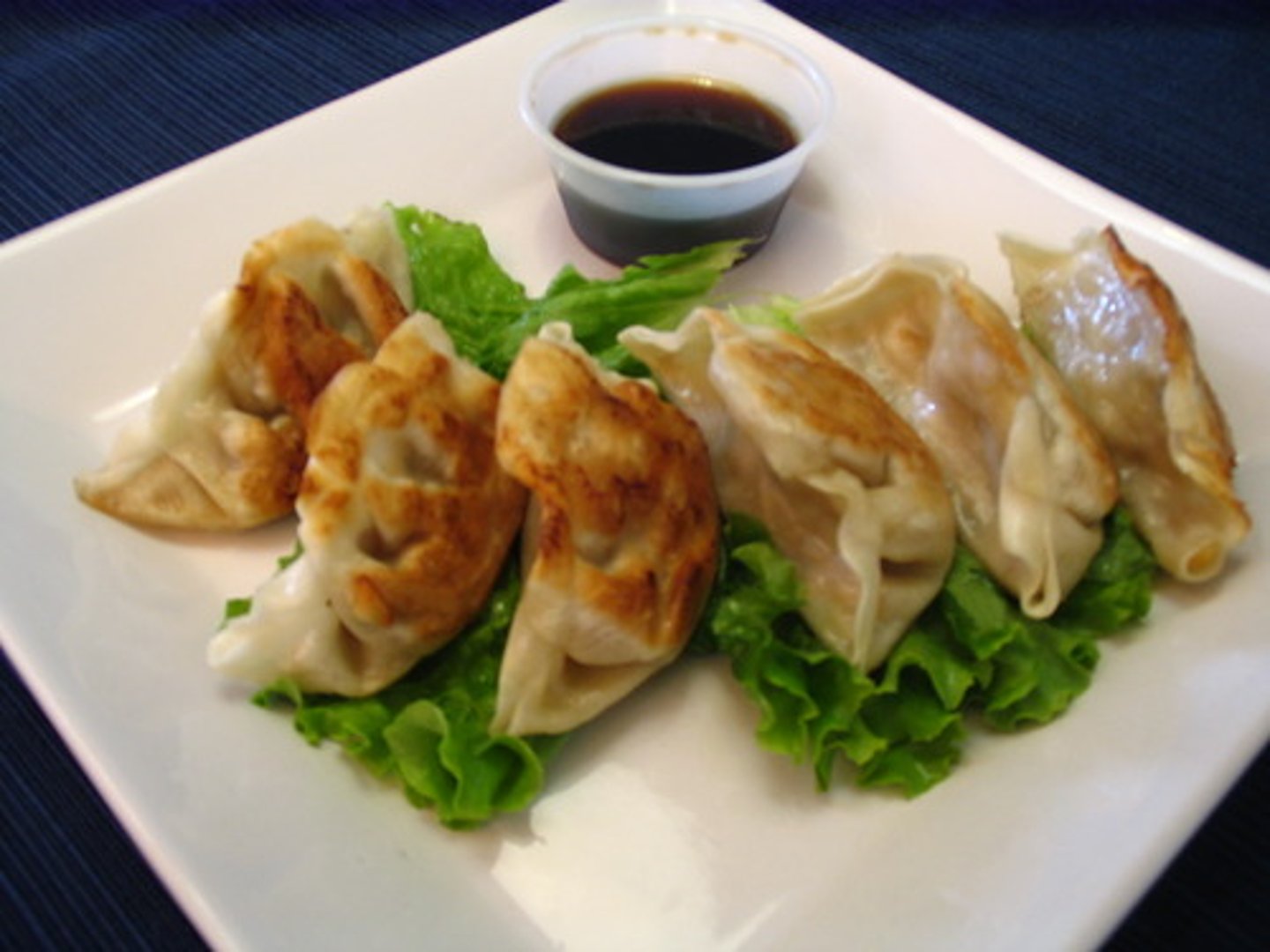 <p>a Japanese dumpling stuffed with minced pork and cabbage</p><p>These take time to put together: I enlist a couple of helpers for <strong>gyoza</strong> folding.</p>