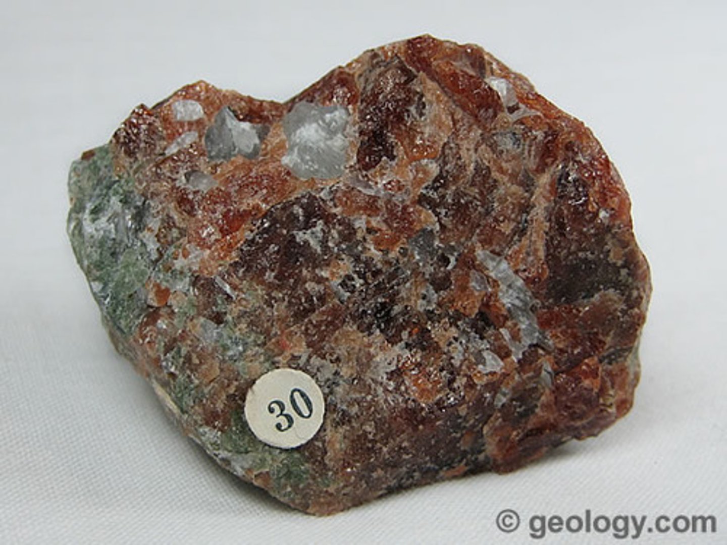 <p>Non Metallic Luster. 7.0 hardness. No streak. 4 S.G. Dark red brown to pink, yellow green or black coloring. No cleavage but may show parting; transparent to translucent; commonly forms dodecahedra.</p>