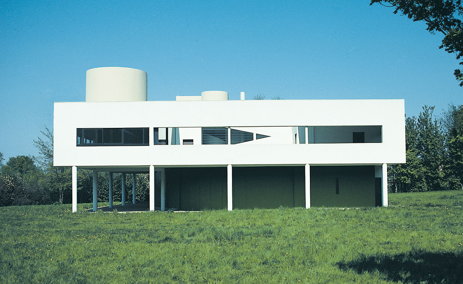 <p>rejection of historical ornamentation in favor of functionality, clean lines, and minimalist aesthetic, emphasizes the rational and efficient use of space, and incorporates modern materials like glass, steel, and concrete to create open floor plans and large windows, (function over form)</p>