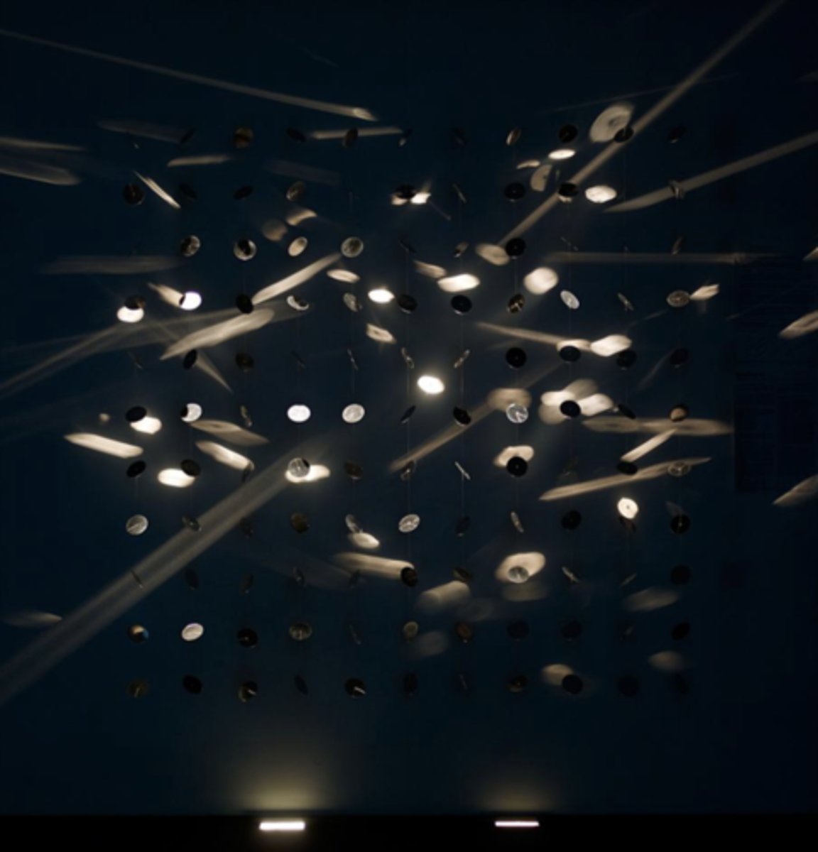 <p>Title: Continuous light mobile<br>Time: 1960s.</p><p>Known for:</p><ul><li><p>System of spotlights used to direct light across the surfaces of the scattered hanging discs.</p></li><li><p>The constantly shifting light and reflections symbolize the <strong>fluidity of perception</strong> and how <strong>reality is never fixed. Art, like life, is in perpetual motion.</strong></p></li></ul><p></p>
