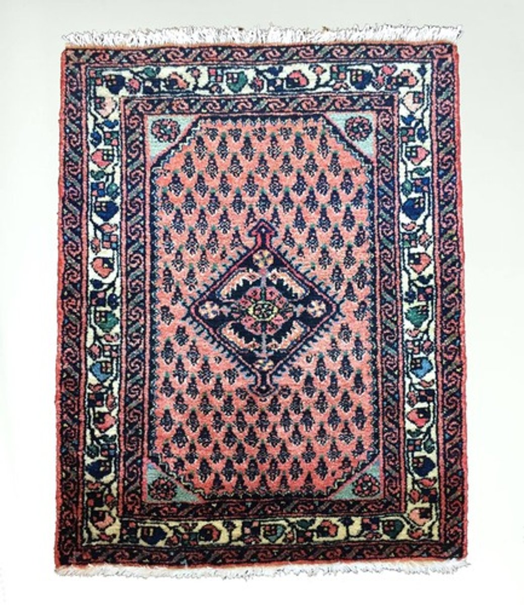 <p>A Persian rug where the entire field covered with a repeating pattern of palm leaves with rose and blue ground. Mir is the name of village in this district where design had its source.The knotting is symmetrical, on a cotton foundation.</p>