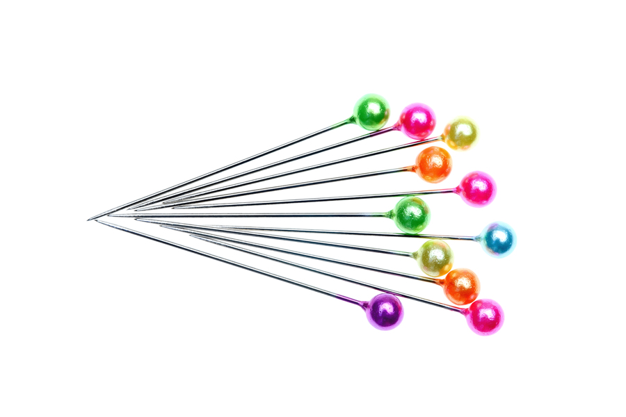 <p>a small, pointed piece of metal or plastic used to fasten items together, often used in crafts or sewing. </p>