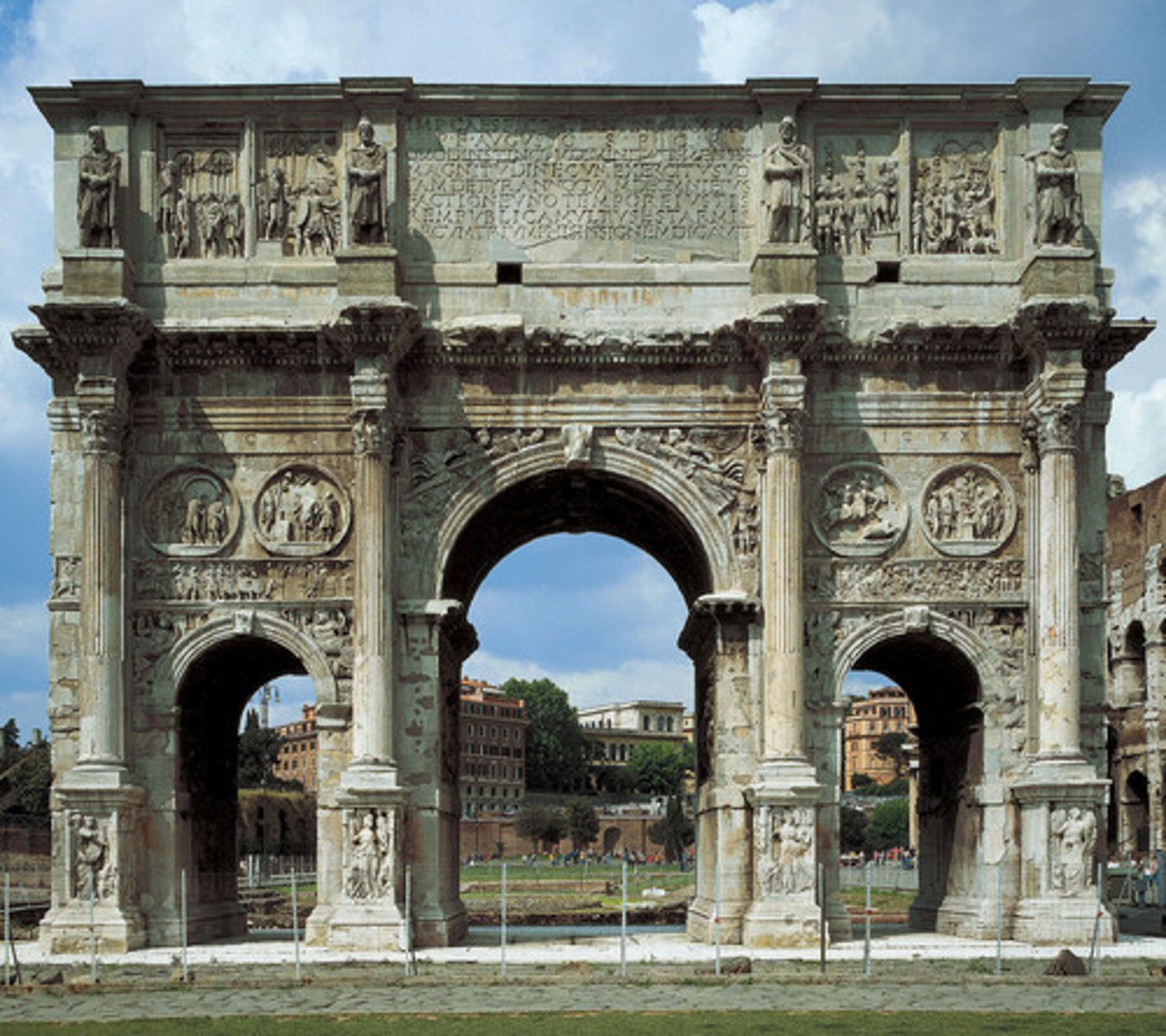 <p>- dedicated in 315 A.D. in honor of his defeat of Maxentius</p><p>- Located near the Colosseum, three archways</p><p>- Decorated with sculpture taken from earlier monuments (Trajan, Marcus Aurelius, Hadrian)</p><p>- Friezes from the time of Constantine - stylistic change, non-naturalistic approach, lacks spatial depth, Constantine is disproportionately large, other figures stumpy, doll-like</p>
