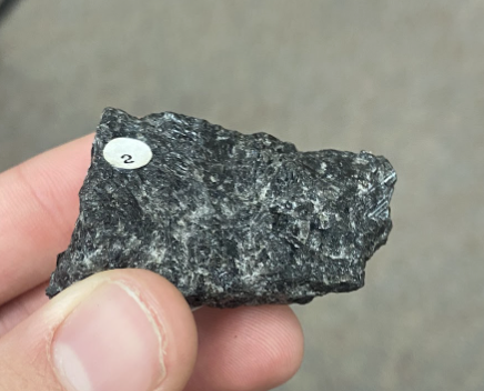 <p>Slightly shiny, rough, Shines in light, Soda lime feldspar common in gabbro, diorites, and basalts, <strong>Road asphalt</strong>, more reflective than mescovite</p>