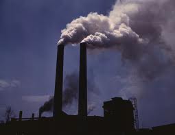 the contamination of the atmosphere by the introduction of pollutants from human and natural sources