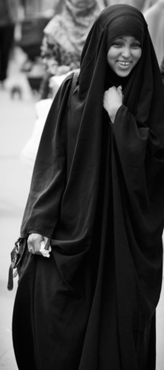 <p>loose black cloak that covers head to feet</p>