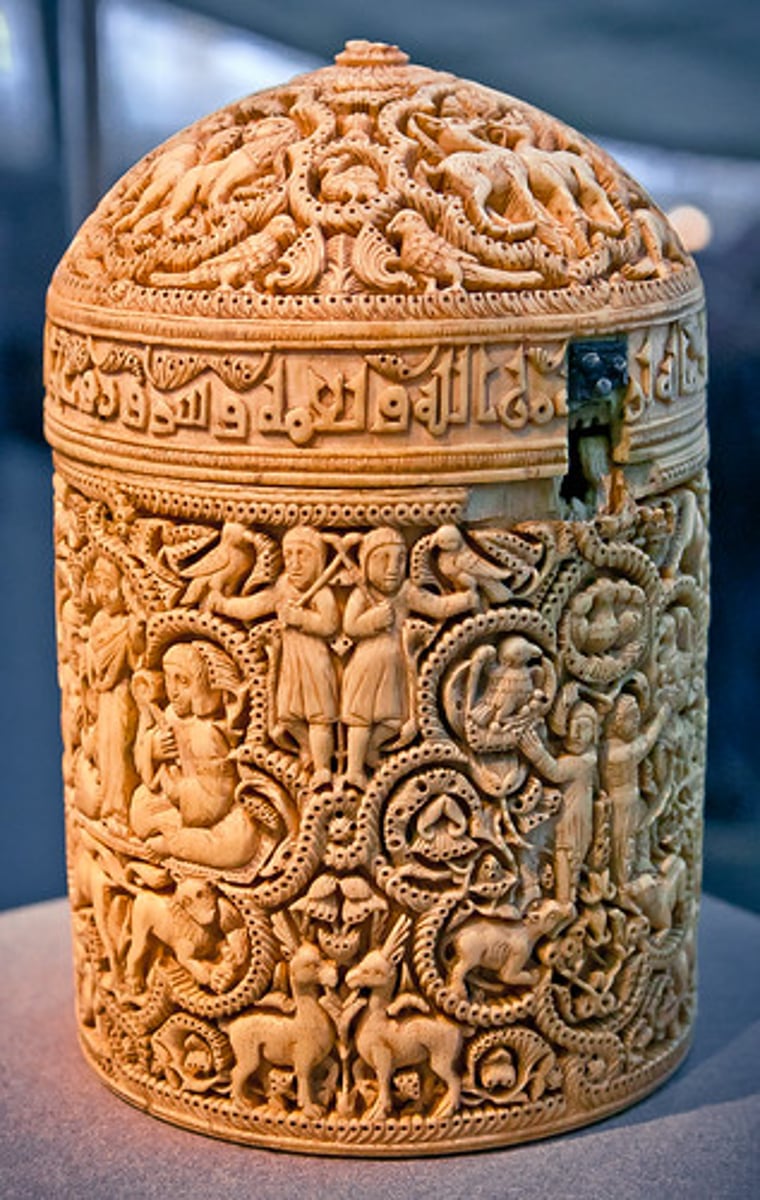 <p>A cylindrical container from the Islamic world, decorated with intricate designs, including depictions of the caliph's life.</p>