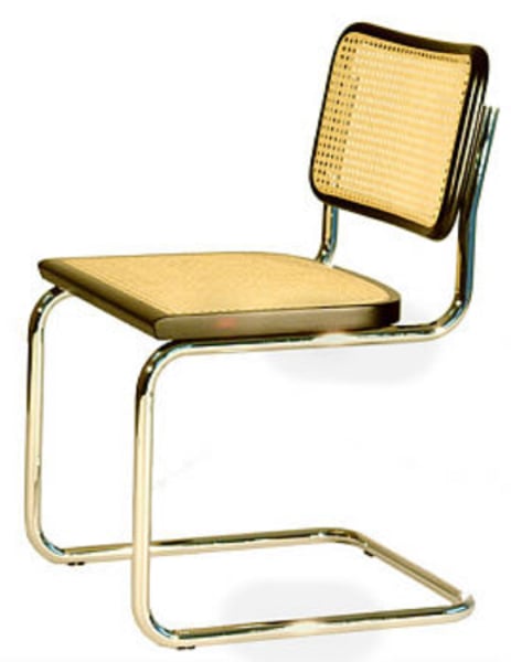 <p>Cantilevered arm chair with metal tubing and cane back and seat</p>