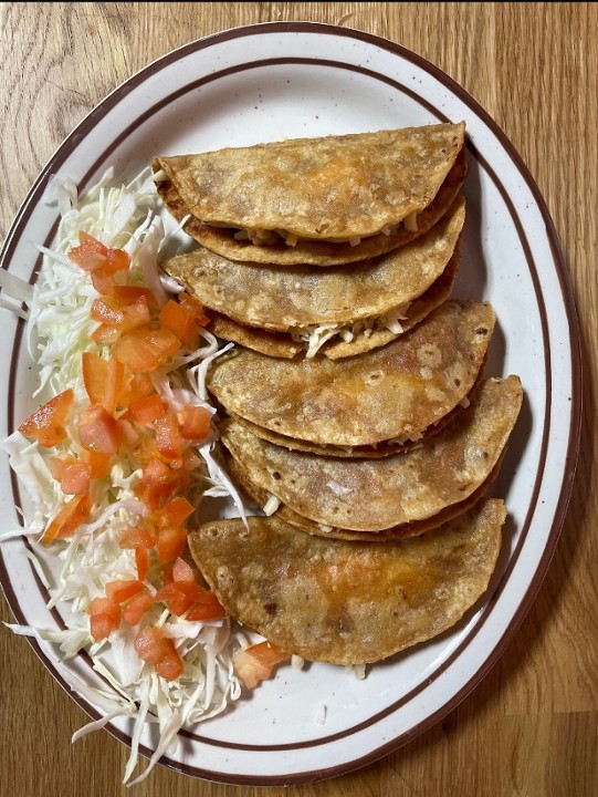 <p>Five corn fried tortillas filled with cumin-spiced potatoes, topped with shredded cabbage, tomatoes, and specialty salsa.</p>