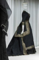 <ul><li><p>dark attire with embellishments</p></li></ul>