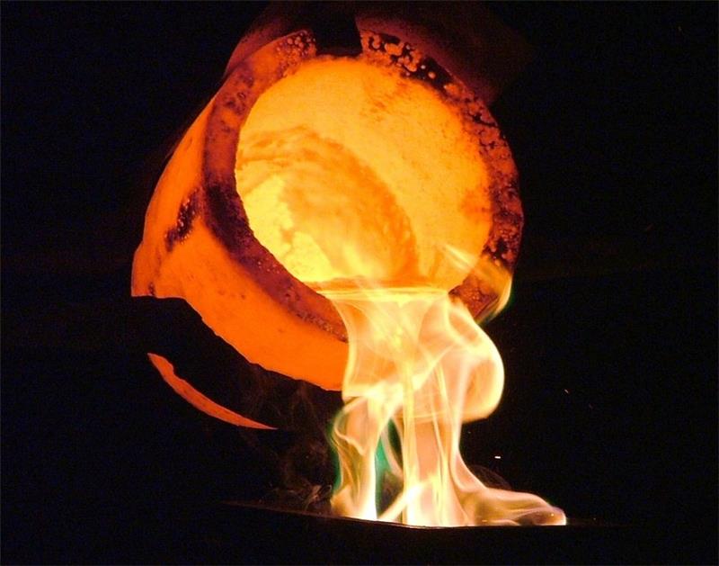 <p>a container for melting or testing metals</p>