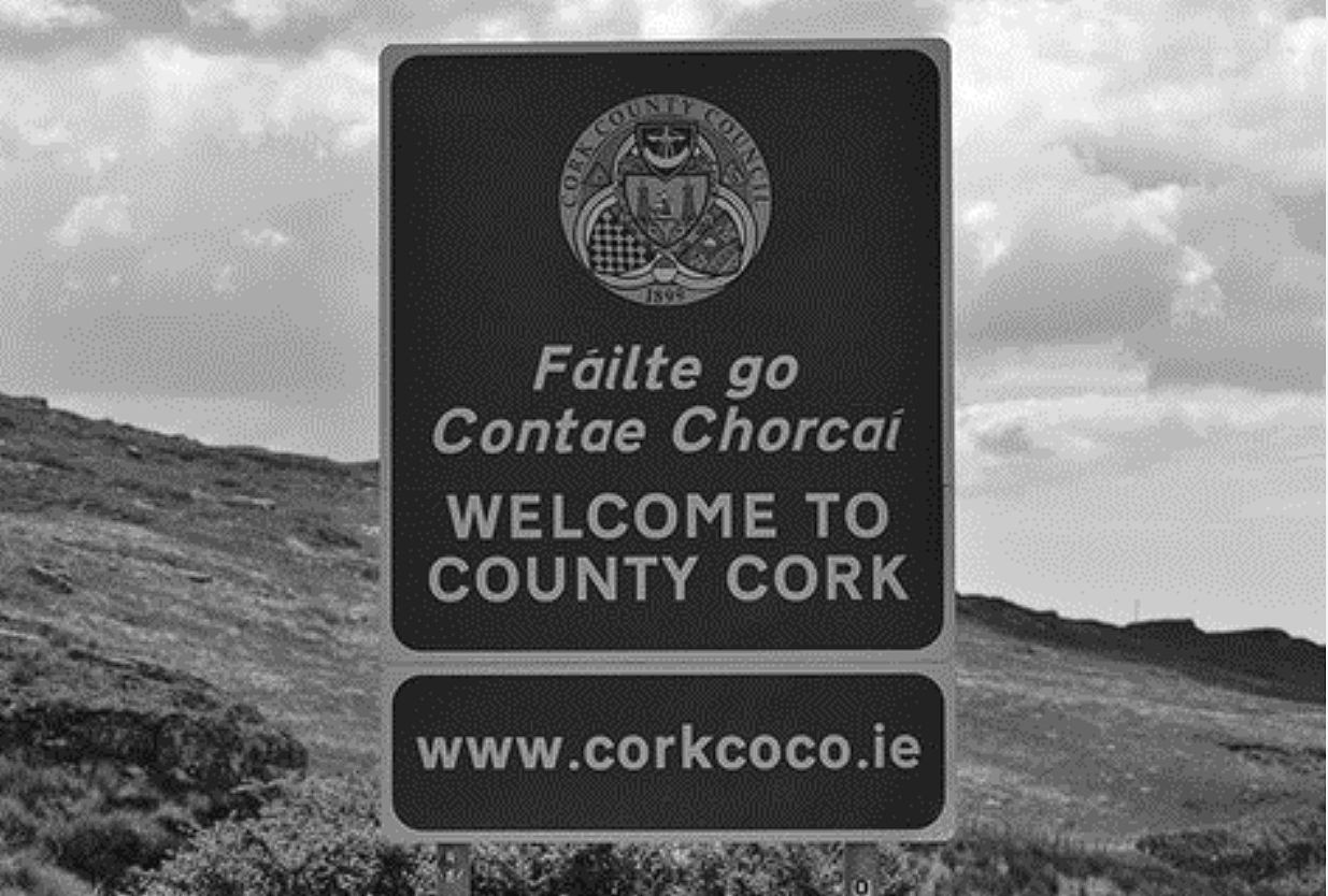 The photograph shows a road sign in the Republic of Ireland. Which of the following best describes the sign’s significance within the cultural landscape?