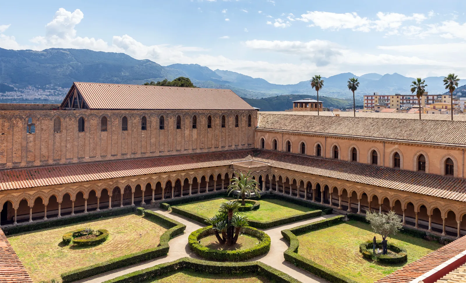 <p><span>A covered walk in a convent, monastery, or cathedral, typically with a wall on one side and a colonnade open to a quadrangle on the other.</span></p>
