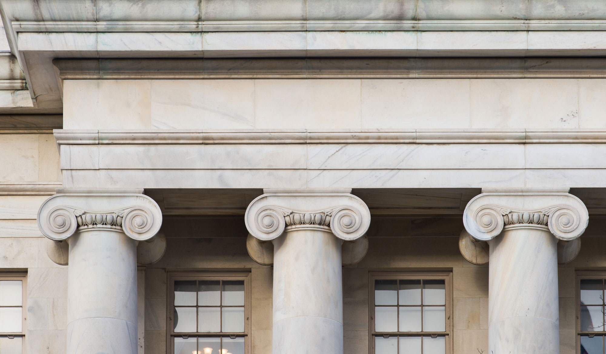 <p>slim pillars, continuous frieze, volutes</p>
