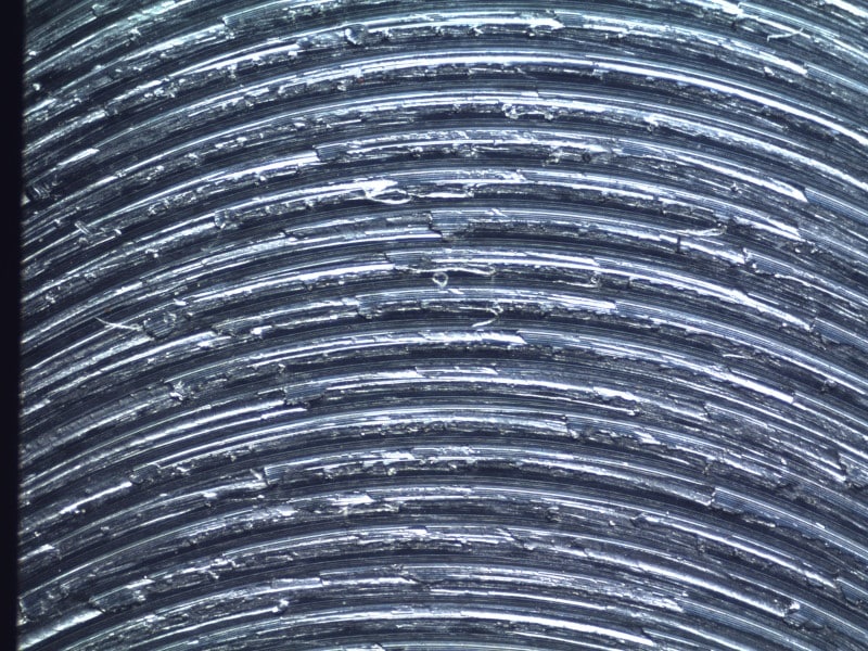 <p>What type of machining likely created these jagged, spaced apart arches?</p>