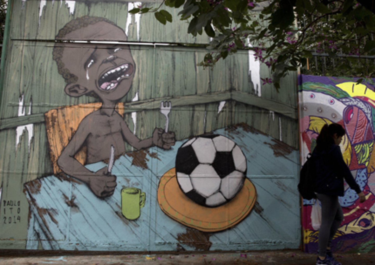 <p>a) Irreverent with sharp social criticism<br>b) Painted on school doors, social media and its ability to interface with street art caused this image to go viral before the World Cup<br>c) Demonstrative of the population that was sharply critical of extravagant government spending on the World Cup despite crumbling national infrastructures in education and heath care</p>