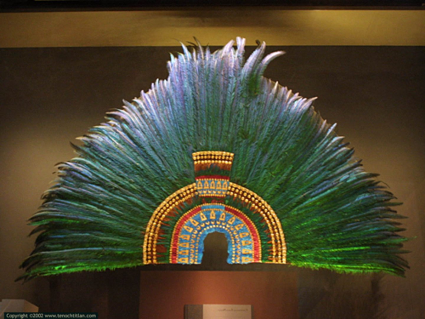 <p>Aztec; 1521 CE</p><p>quetzal feathers</p><p>function= symbolize divine power of king</p><p>materials are kingly; jade discs, gold beads</p><p>rituals done while making</p><p>sacred parts = top of head and backbone</p>