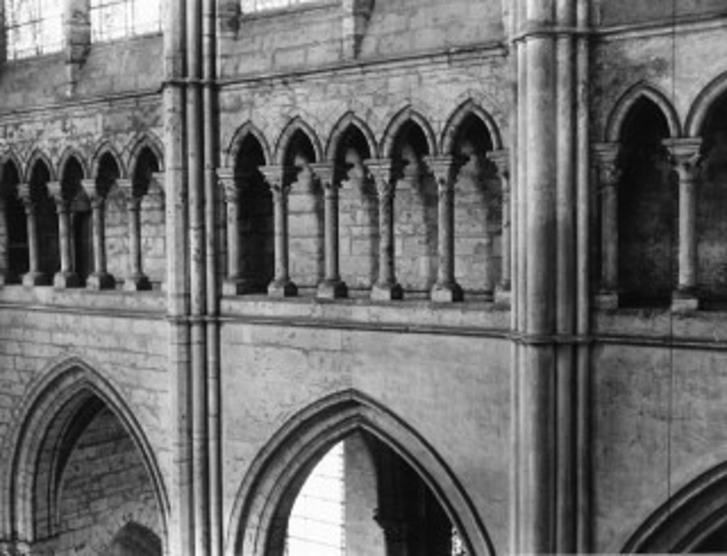 <p>A shallow, arcaded passageway or gallery in a Gothic cathedral, located between the large nave arcade on the ground floor and the clerestory windows high above. It is a key part of the cathedral's three-part vertical elevation (arcade, triforium, clerestory) and can be a blind arcade with no internal passage, or contain a narrow, hidden walkway. Its primary functions are decorative, contributing to the sense of verticality and lightness, and historically, it served a structural role as a passage for workmen to access the roof space. (this tended to replace nave arcade)</p>