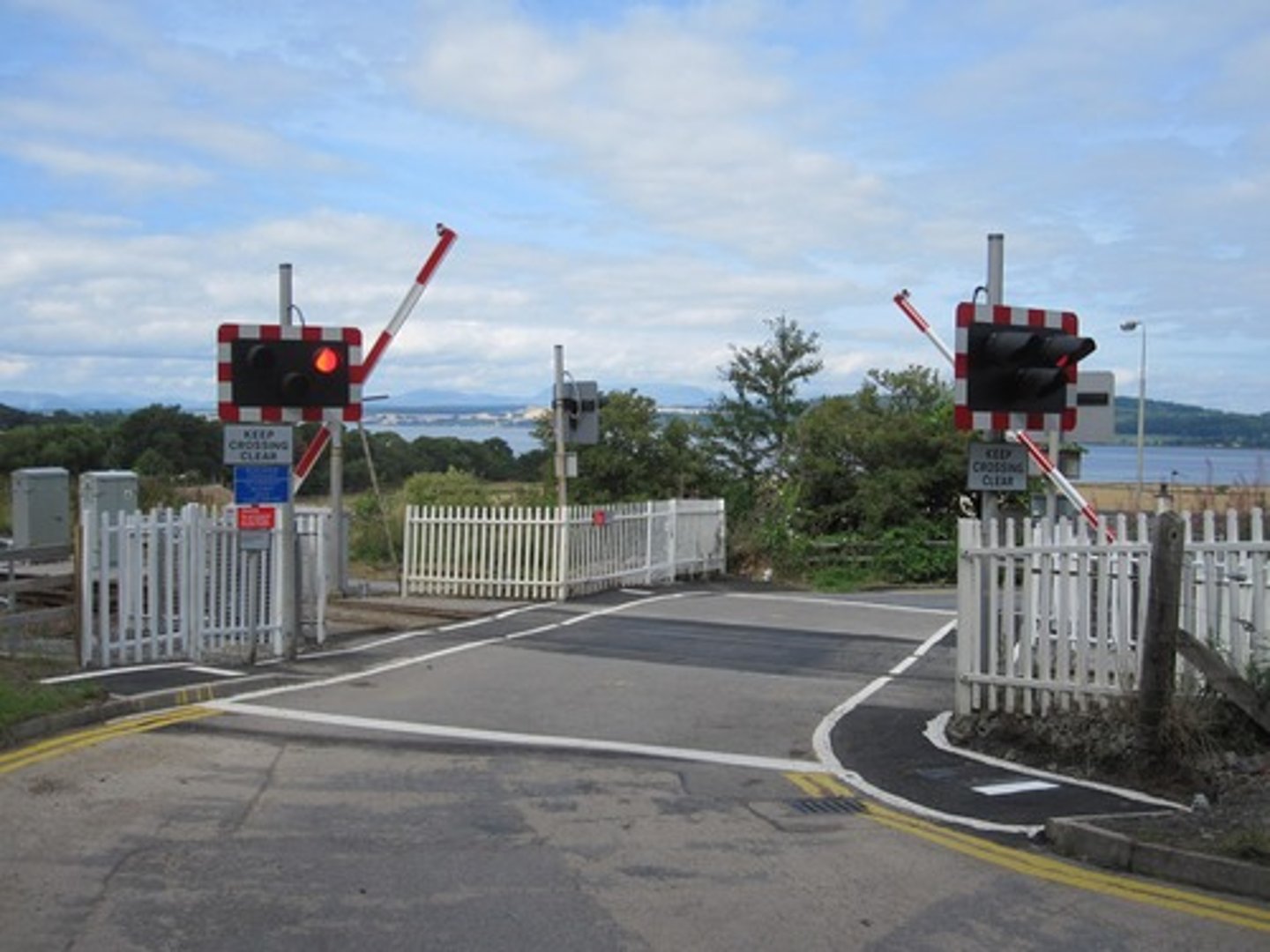 <p>where a <strong>railway crosses </strong>a road</p>