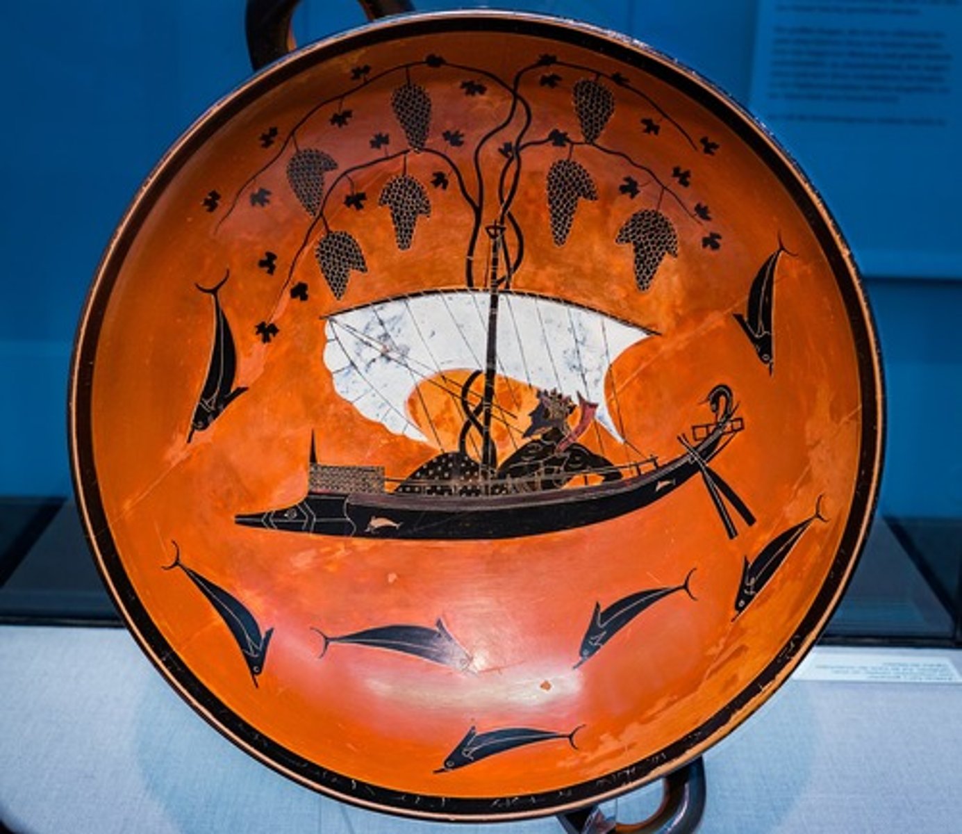 <p>Who The Eye-cup, also known as the "Dionysus Cup," was created by Exekias1, an artist from the ancient Greek city-state of Athens1.</p><p>What The Dionysus Cup is a kylix (drinking cup) dating to 540-530 BC1. It is one of the masterpieces of the Attic black-figure potter Exekias1. The inside image, the tondo, takes up almost the entire interior of the cup. In the center, a sailing ship is depicted, traveling from right to left. Within the ship is a well over life-sized figure, the god Dionysus1. Vines grow from the mast, with three large clusters of grapes on the right and four on the left. Dolphins swim below the ship—two towards the right, three towards the left—and a further dolphin is found on the right and the left-hand sides of it1.</p><p>Where The Dionysus Cup is now housed in the Staatliche Antikensammlungen in Munich1.</p><p>When The Dionysus Cup dates back to around 540-530 BC1.</p><p>Why The Dionysus Cup is interesting and important for several reasons:</p><p>Artistic Significance: The cup shows numerous technical innovations. As a potter, Exekias took older forms and reshaped them into a completely new one2. This form, the so-called Cup type A with a thicker foot, a ring around the stem, and a deep, broad bowl, would quickly become the dominant form2.</p><p>Cultural Significance: The cup depicts Dionysus in a sailing ship surrounded by dolphins3. This scene could be a reference to the seventh Homeric Hymn, in which it is explained how Dionysus was kidnapped by Etruscan pirates, who were unaware of his identity. The god confuses their thoughts and causes them to jump into the water, where they transform into dolphins2.</p><p>Historical Significance: The images around the handles probably depict the battles for the corpses of Patroclus and Achilles, with the naked corpse being Patroclus2.</p>