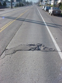<p>breakdown, chip, disintegration of slab surface at edges, joints, corners or cracks</p>