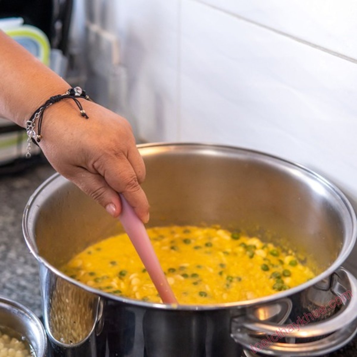 <p>khuấy súp bằng cái muỗng</p>