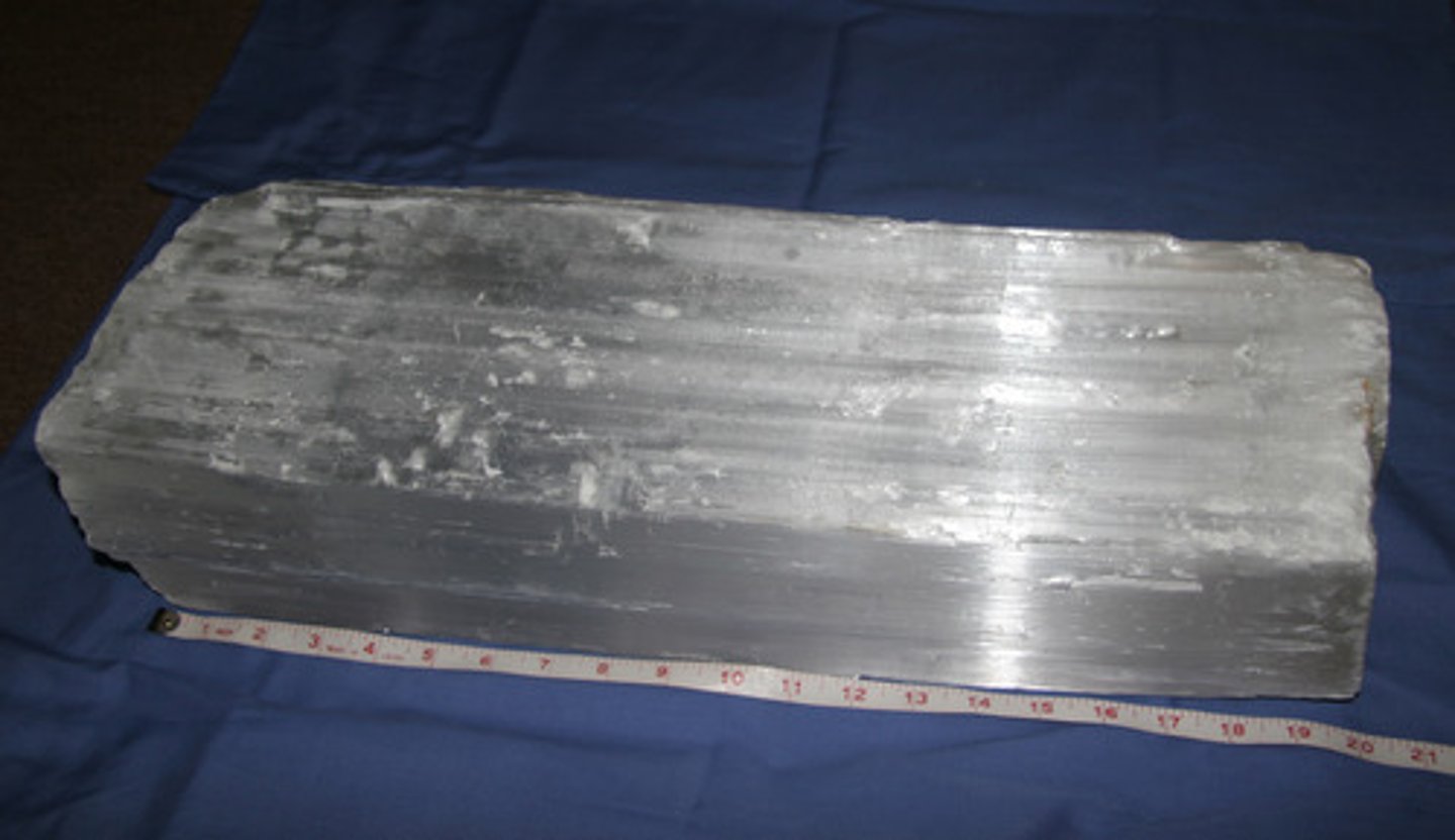 <p>Is a fibrous variety of gypsum with a pearly luster.</p>