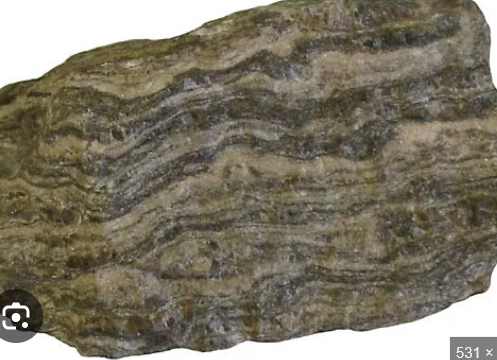 <p>a texture in metamorphic rocks characterized by the alternation of light and dark bands due to the segregation of mineral phases during metamorphism. </p>