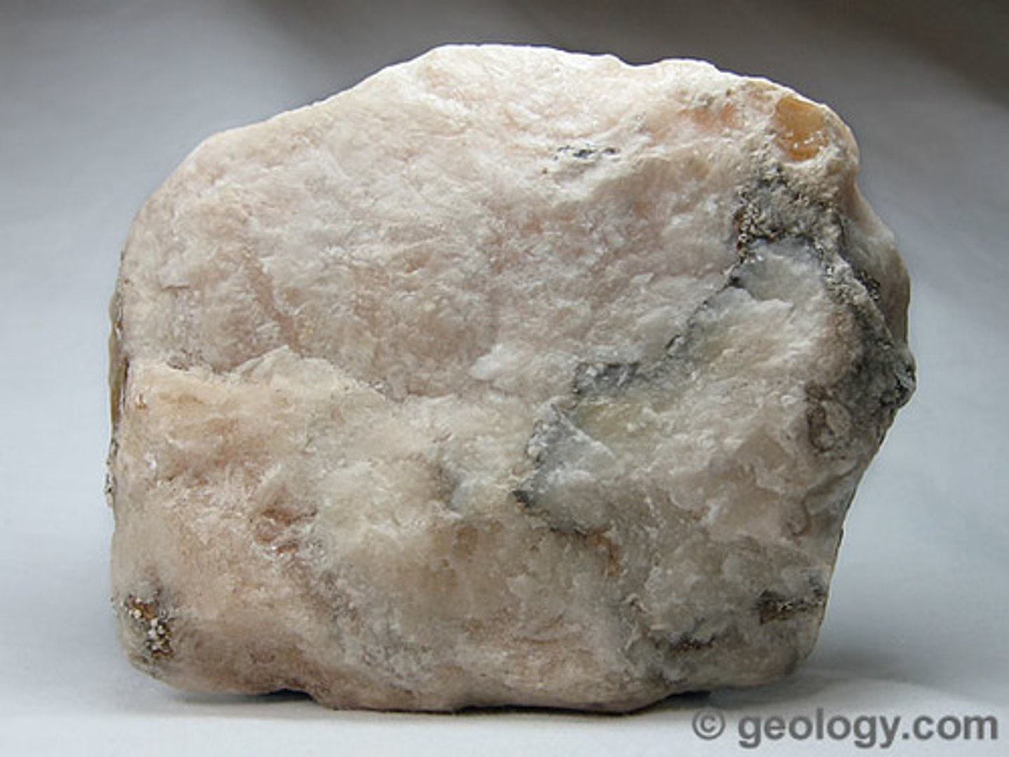 <p>Non Metallic Luster. 2.0 hardness. White streak. 2.3 SG. Colorless, white, may be colored orange by iron oxide; non-greasy feel, colorless sheets, fibrous-silky masses, or massive.</p>