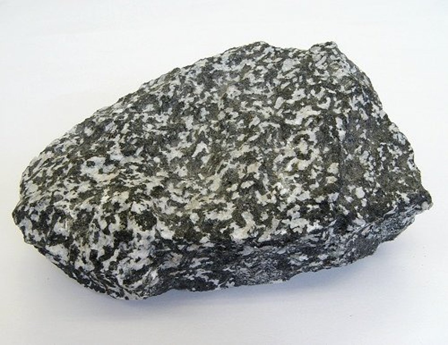 <p>Texture: Phaneritic</p><p>Color: Grey (70/30 black and white)</p><p>Minerals: albite, labradorite, quartz, biotite,muscovite, hornblende, augite</p><p>Composition: intermediate</p><p>Formation: Slow cooling of magma, intrusive</p><p>Location: Convergent boundary beneath the continental crust</p>