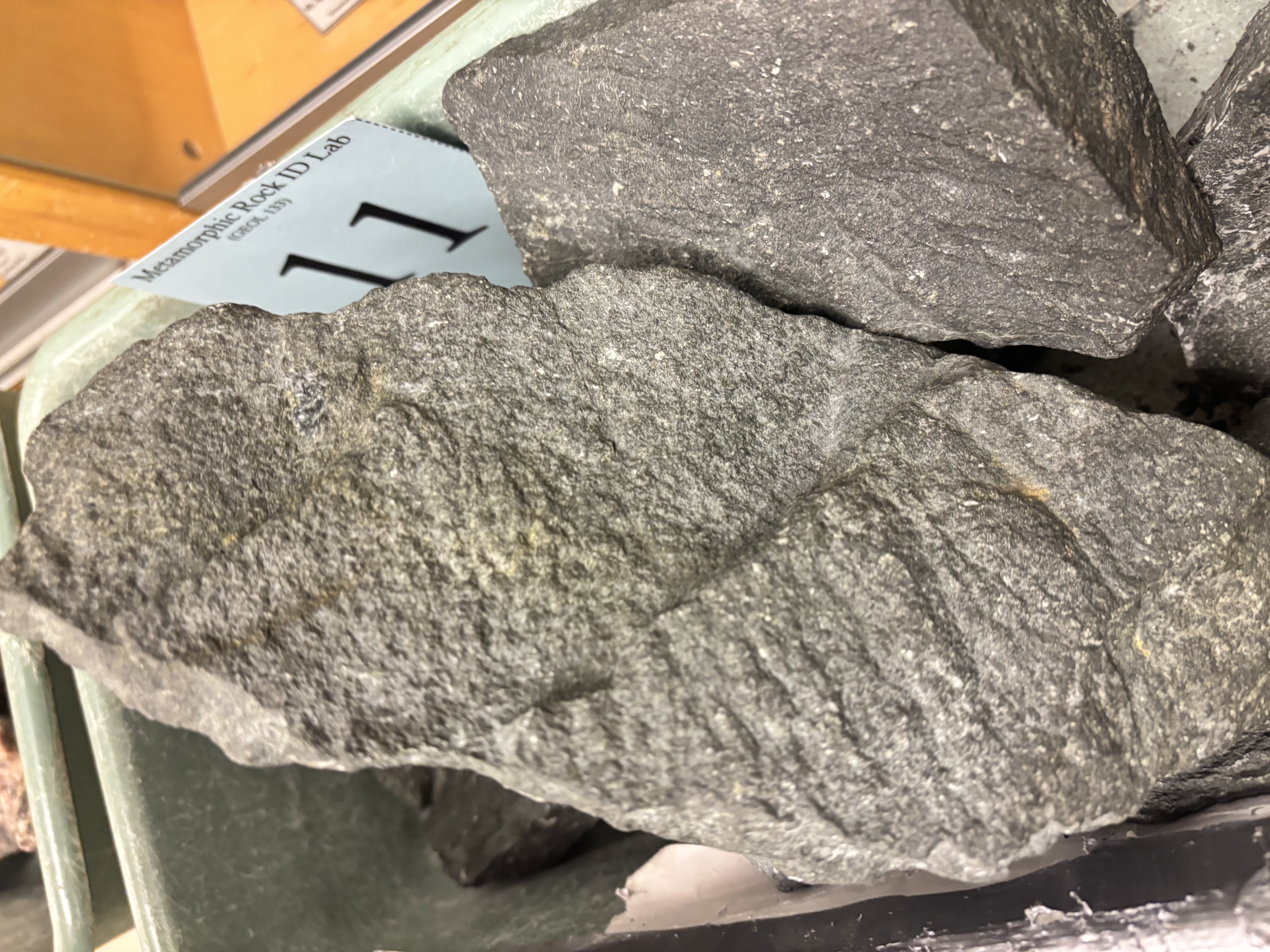 <p>Metamorphosed basalt; green color from chlorite, epidote, or actinolite; low-grade.</p>