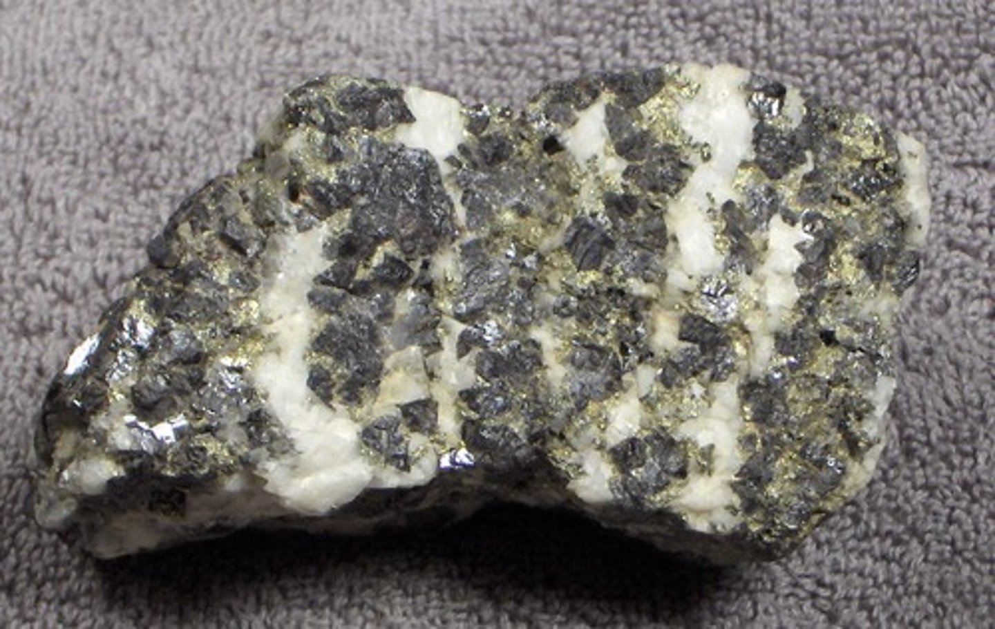 <p>a rock that contains a large enough concentration of a mineral making it profitable to mine</p>