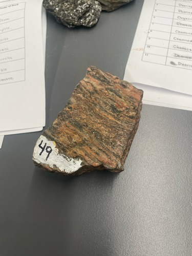 <ul><li><p>Striped with light and dark minerals</p></li><li><p>Coarse grained </p></li><li><p>Foliated, gneissic banding</p></li><li><p>High metamorphic grade</p></li></ul>