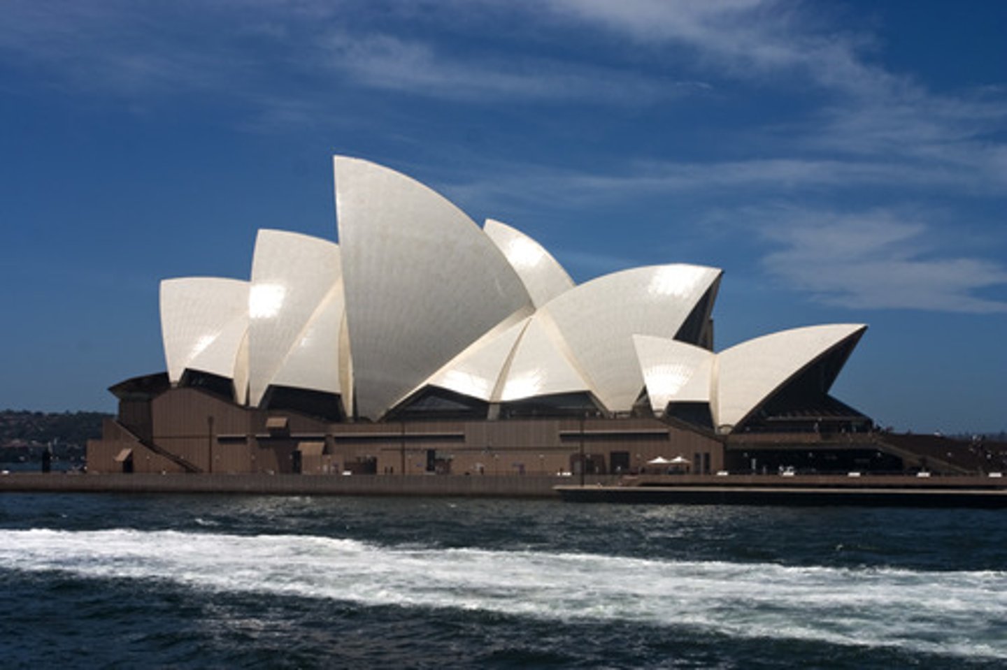 <p>Designed by Danish architect Jørn Utzon, who won the competition with a dramatic design showing a complex of two main halls side by side facing out to the harbour on a large podium. Each hall was topped with a row of sail-shaped interlocking panels that would serve as both roof and wall, to be made of precast concrete.</p>