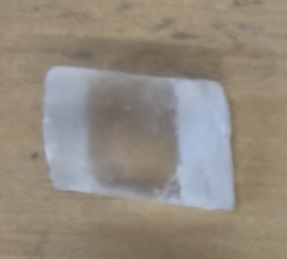 <p>rhombus, clear, reactes with hcl</p>