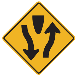 The highway ahead is divided by a median or physical barrier. Keep to the right.