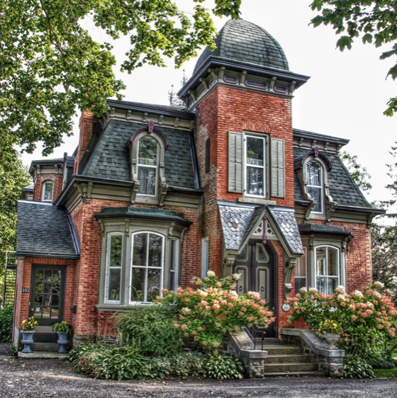 <ul><li><p>centered tower or </p><p class="p1">cupola</p></li><li><p class="p1">mansard</p></li><li><p class="p1">one story porch</p></li></ul><p></p>