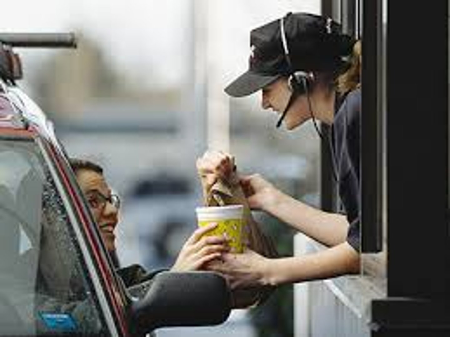 <p>(n) a place where you can get some type of service by driving through it, without needing to get out of your car</p>